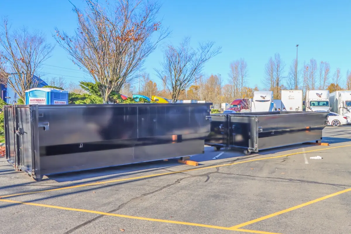 Professional dumpster rental service with roll-off container on residential driveway in Escalon